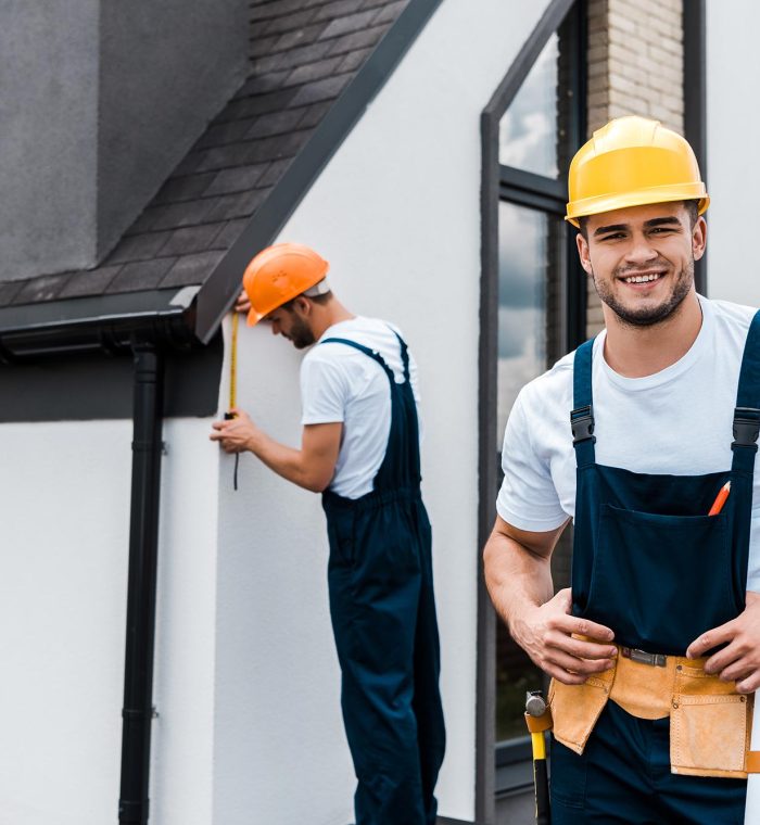 selective-focus-of-happy-handyman-in-uniform-near-service.jpg